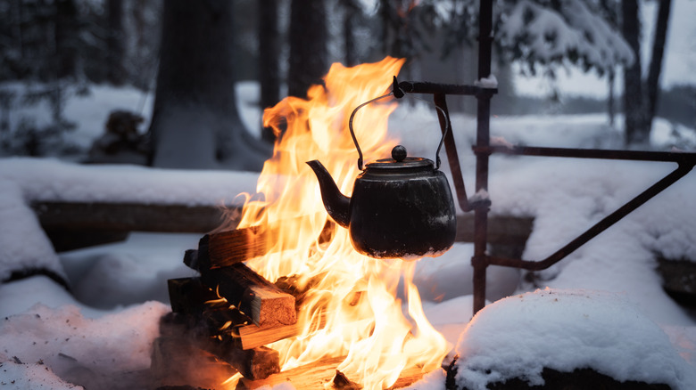 Teapot over fire in the snow
