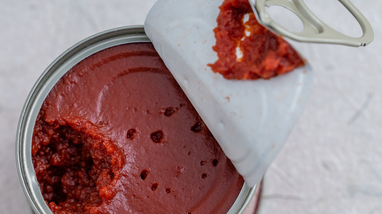 Can of tomato paste, with the inside exposed