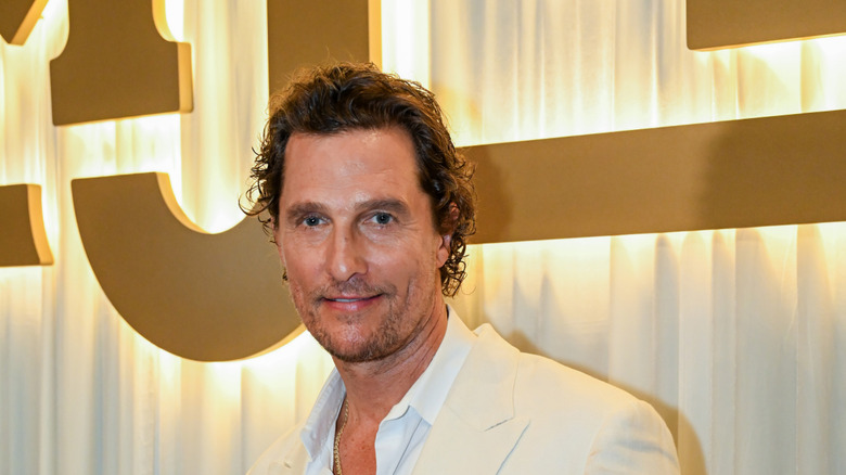 Matthew McConaughey in a tan jacket and white shirt