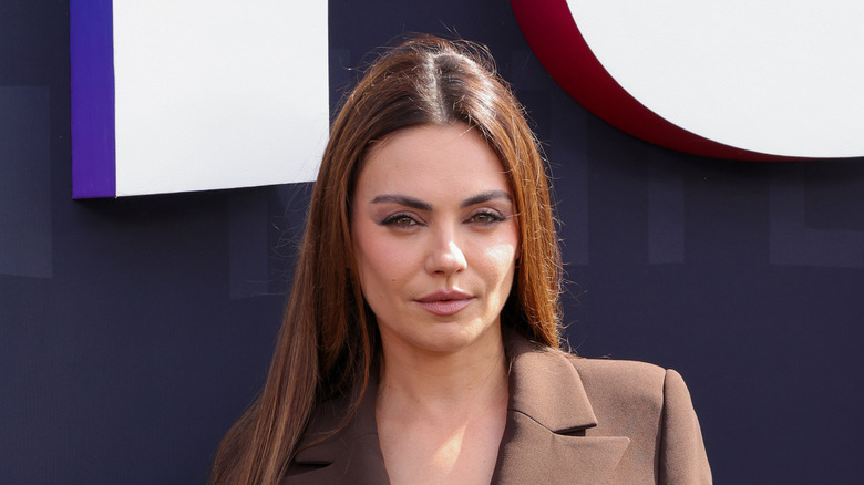 Mila Kunis wearing a brown suit jacket