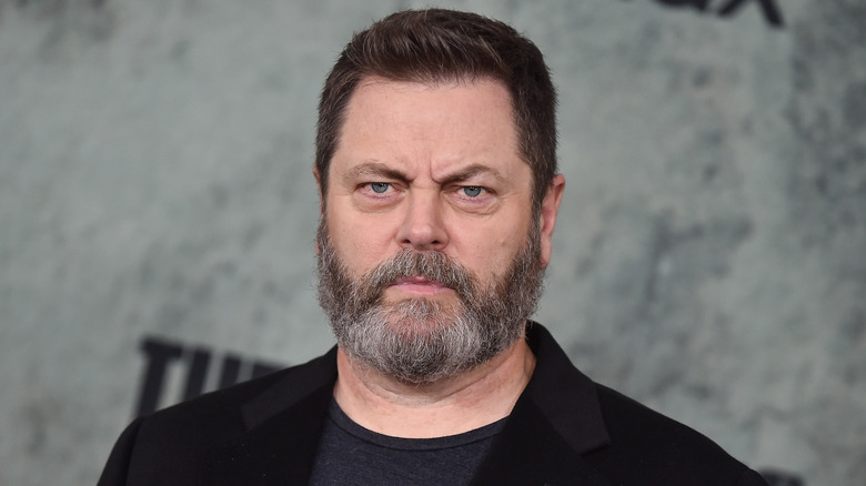 Nick Offerman wearing a black shirt and jacket