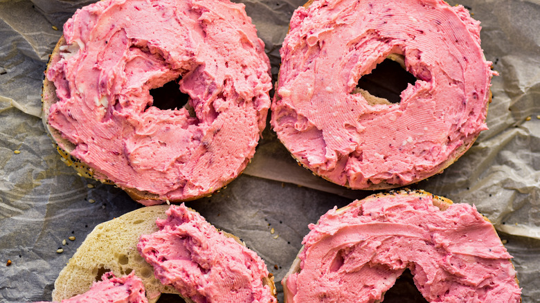 Pink spread on sliced bagels