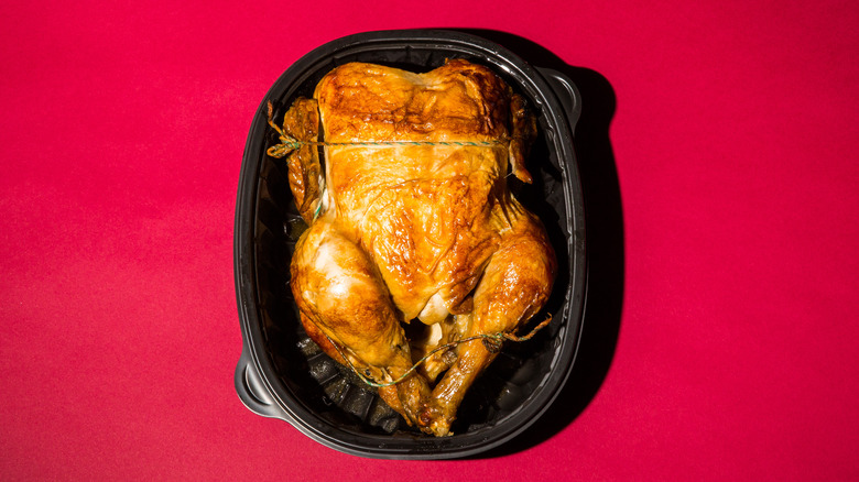 Rotisserie chicken on red background