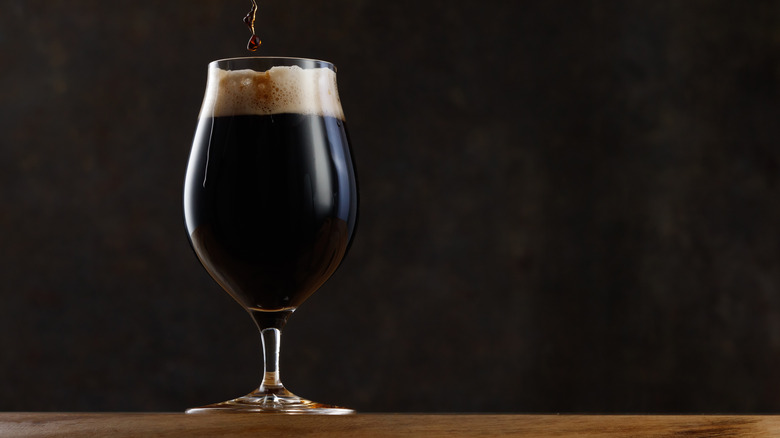 Glass of dark beer on a table