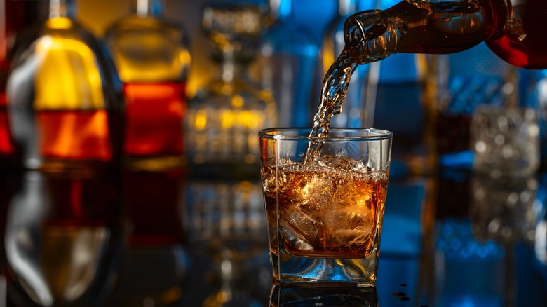 Whiskey is poured into a glass