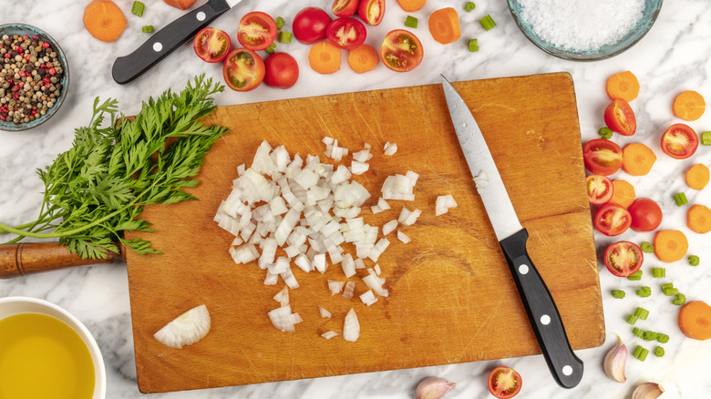 Various chopped ingredients arranged around chopping board