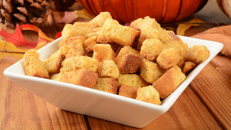 Crunchy cornbread croutons in a white bowl