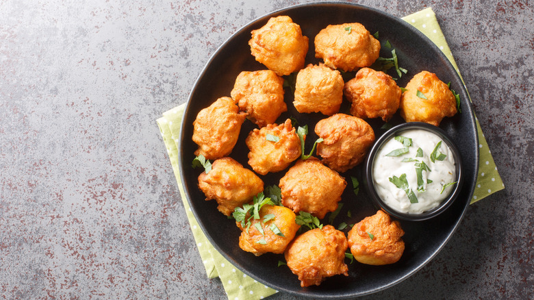 Plate of cornbread hush puppies with dipping sauce