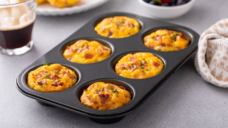 Cheesy breakfast muffins with bacon in a muffin dish