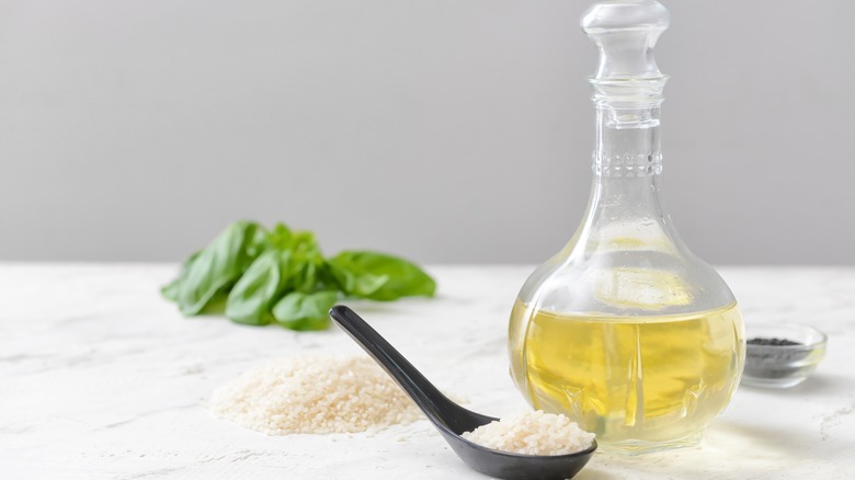 Bottle of rice vinegar and spoon of rice