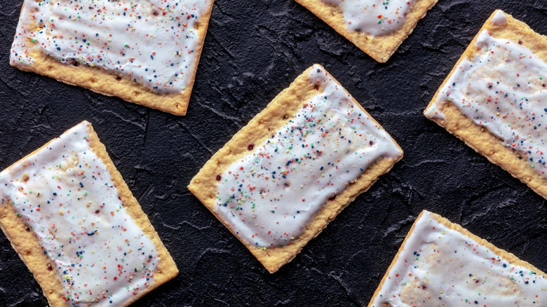 Pop-Tarts with frosting and sprinkles against a dark background