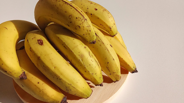 Bunch of bananas on a wooden board