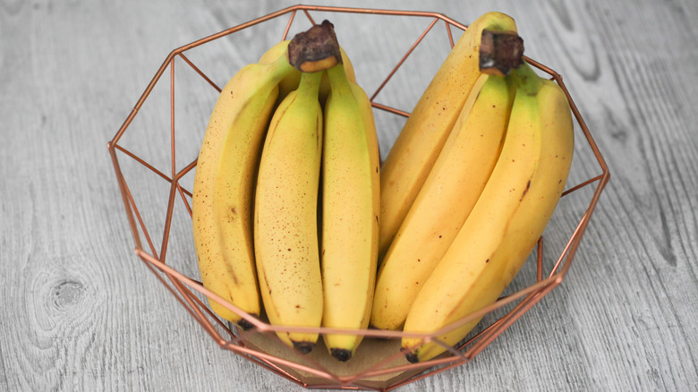 Bunches of bananas in a wire fruit bowl