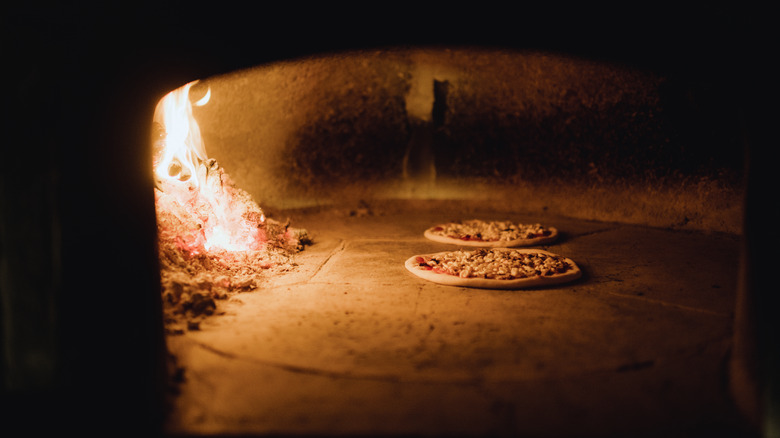 Pizzas sitting in wood fired oven