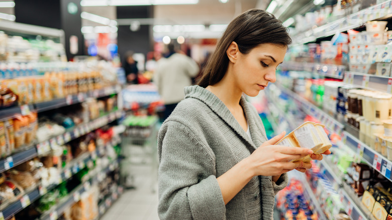 woman reading expiration date