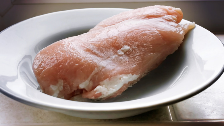 thawing frozen chicken in bowl