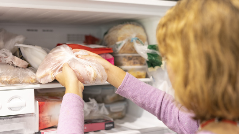 putting bags of meat in freezer