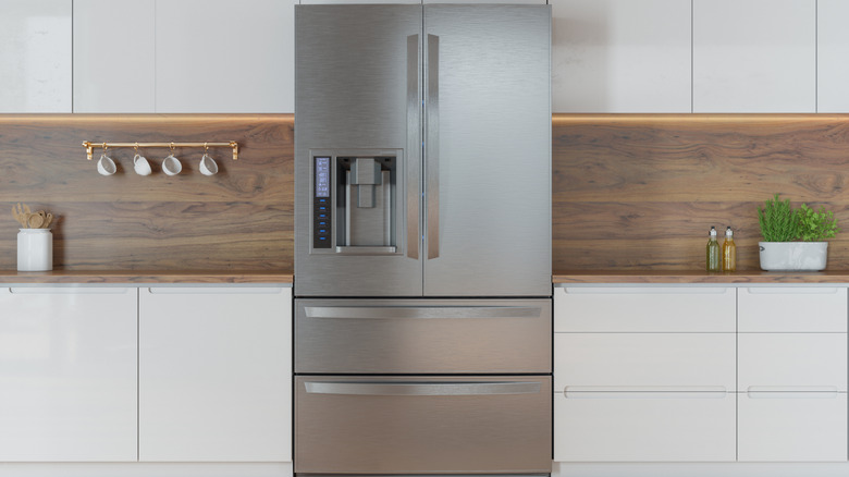 A modern kitchen, with a large silver refrigerator in its center