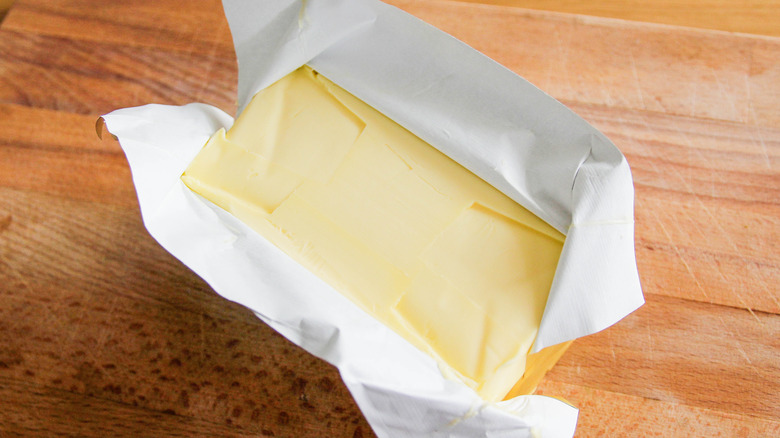 White plate with chunks of golden fresh butter