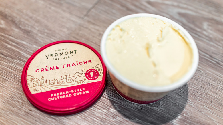 Close up of open container of crème fraîche
