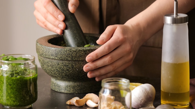 making pesto in mortar and pestle