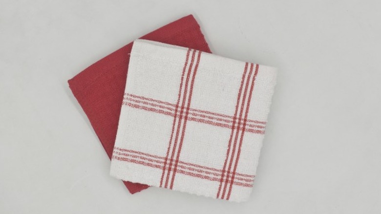 A red and red plaid dish rag on a white background