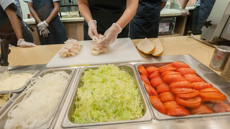 A worker builds sub sandwiches in a Jersey Mike's