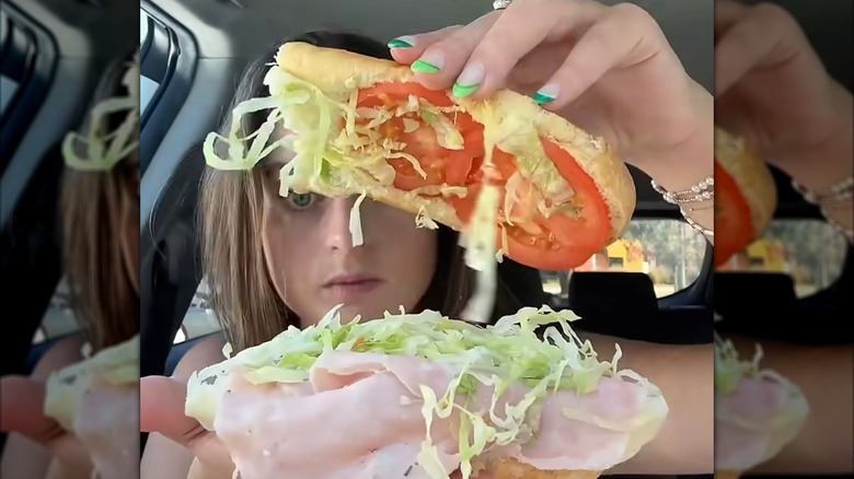 A food influencer holds open a Jersey Mike's kids sandwich