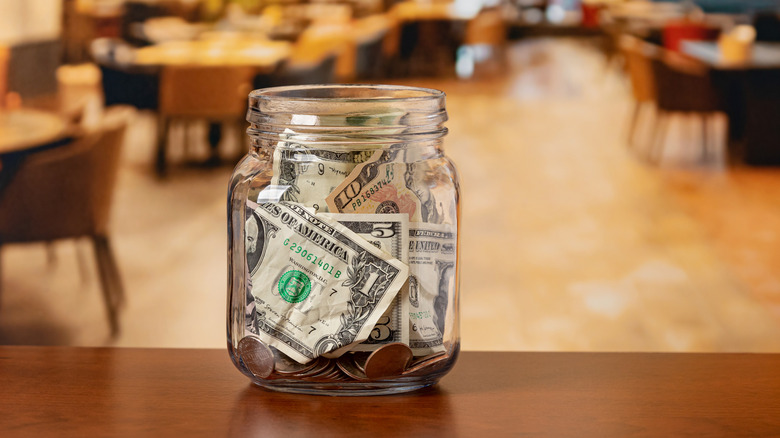 A tip jar sits on a counter