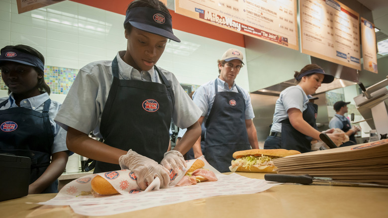 Jersey Mike's workers make sandwiches in-store