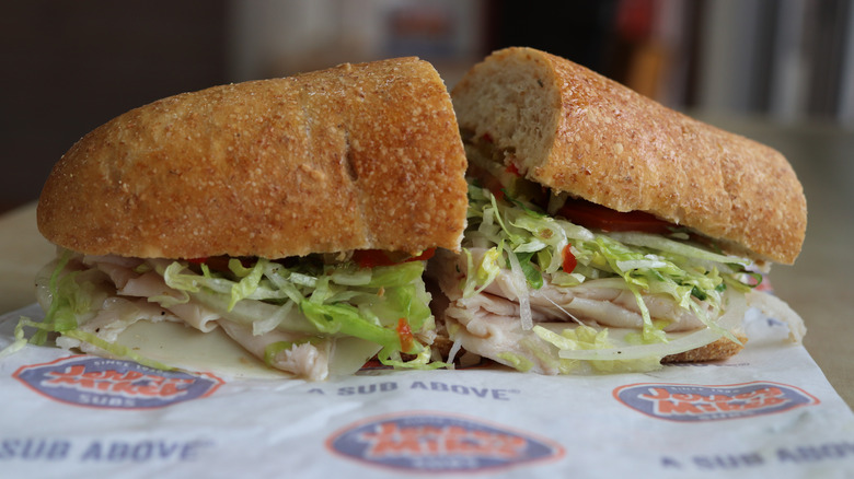 A Jersey Mike's sub sits on its wrapper