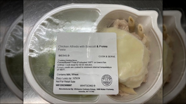 Plastic container of Whitsons Food Service Corp. Chicken Alfredo with Broccoli & Penne Pasta