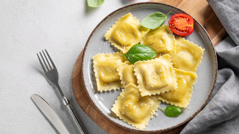 Plate of ravioli, with basil, tomato, and cheese