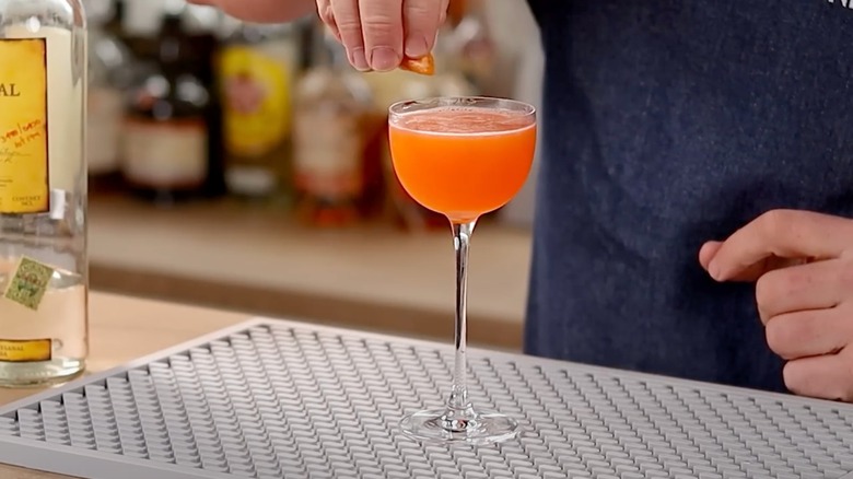 A bartender makes a Division Bell cocktail