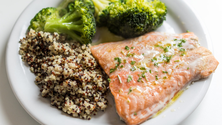 A plate of salmon, quinoa, and broccoli