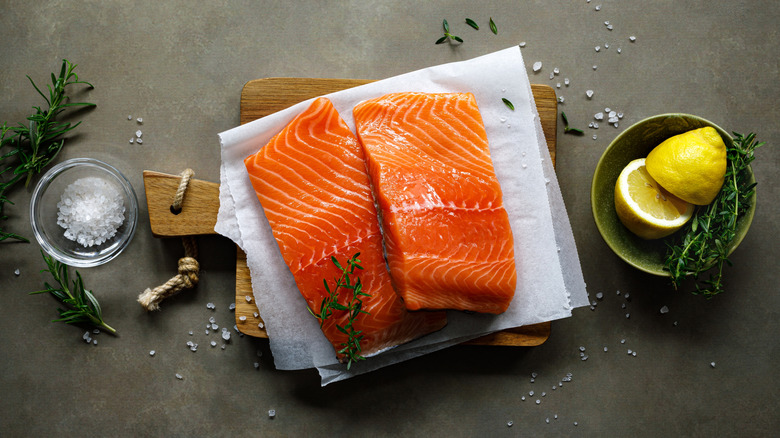 Raw salmon fillets surrounded by seasonings