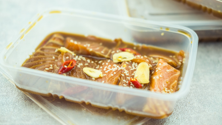 Salmon marinating in a soy sauce, chili, sesame, and garlic marinade