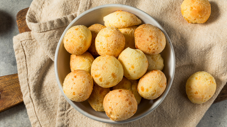 Brazilian cheese bread rolls in bowl on towel