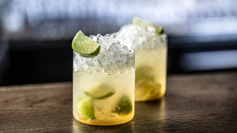Glasses of caipirinha on wooden table