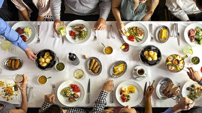 Fogo de Chão dining table with several people around it viewed from above