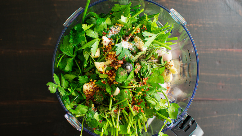 Chimichurri ingredients in a food processor