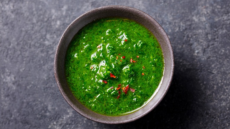 Small bowl of chimichurri sprinkled with red chili flakes