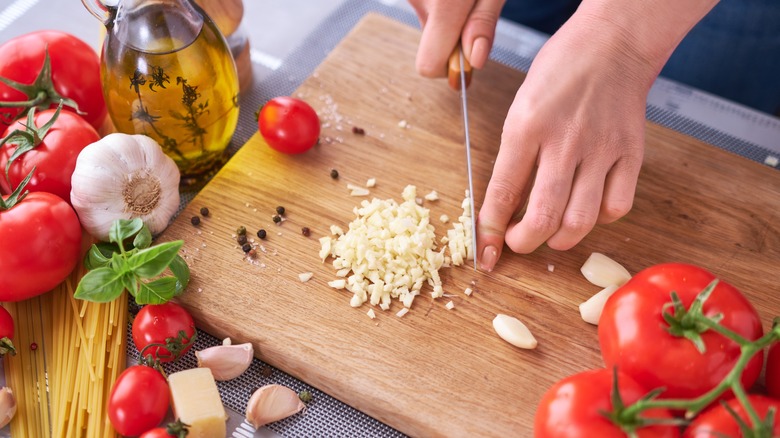 mincing garlic on cutting board
