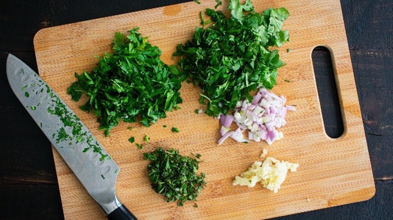 garlic and herbs on cutting board