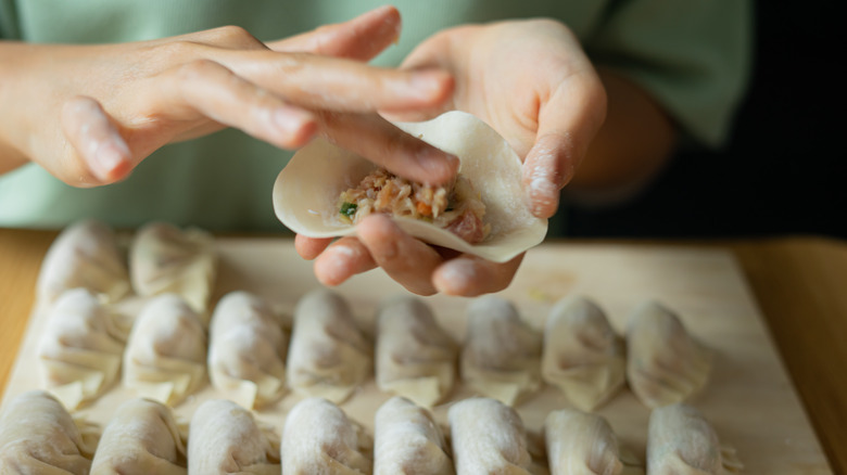 person filling a dumpling