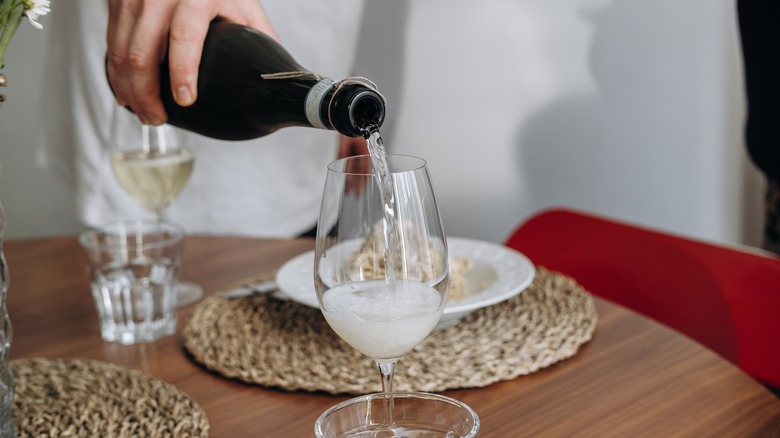 Glass of prosecco being poured in a restaurant