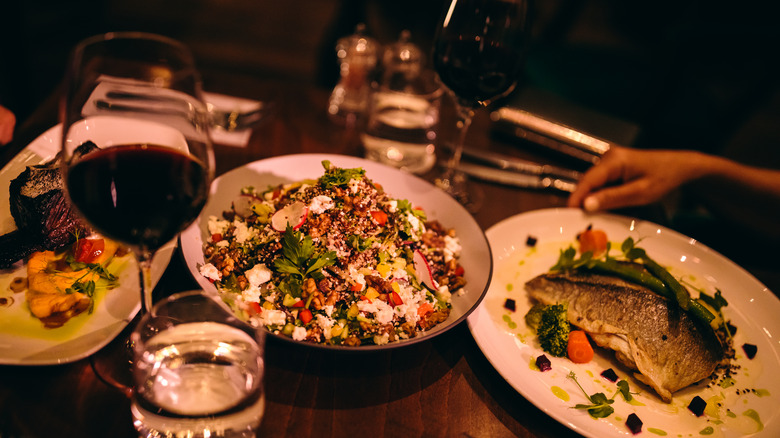 glasses of red wine with salad and fish