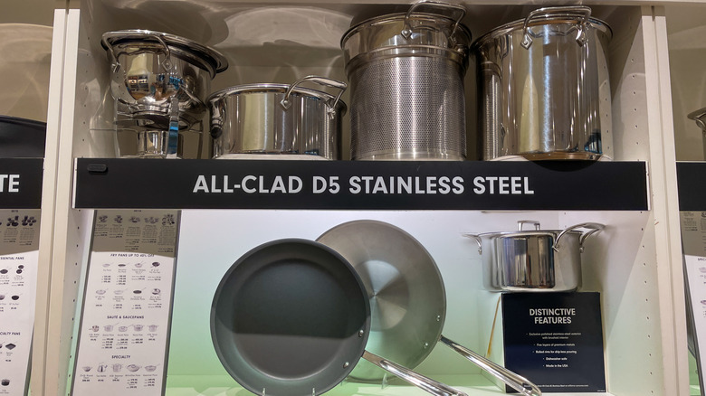 A selection of All-Clad cookware on display in a store