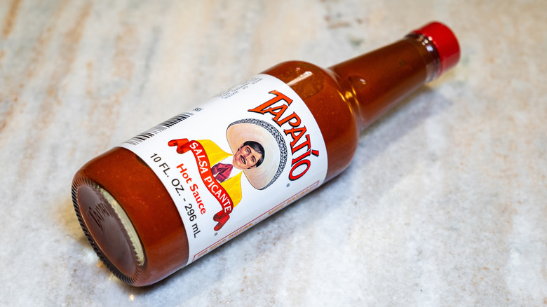 A bottle of Tapatío hot sauce on its side