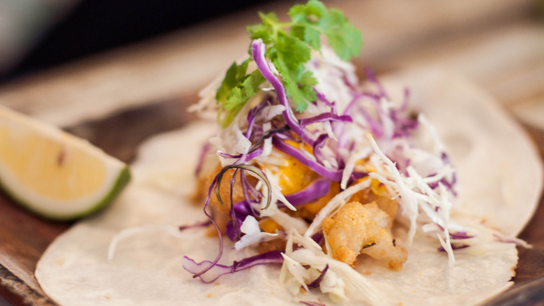 Close-up of a taco topped with red cabbage slaw